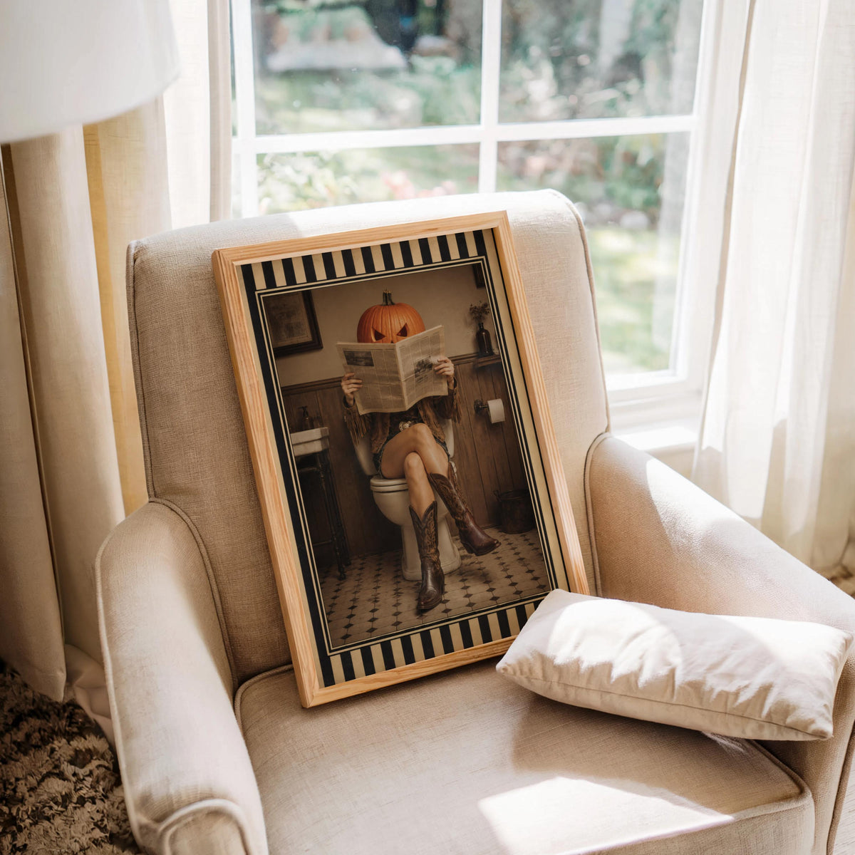 Cozy armchair with framed pumpkin head cowgirl art print on the cushion, surreal western art for bathrooms