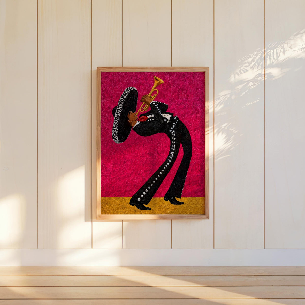 Hot pink mariachi wall art print centered on white panel, sunlit walls, lively Latin music wall art for modern interiors