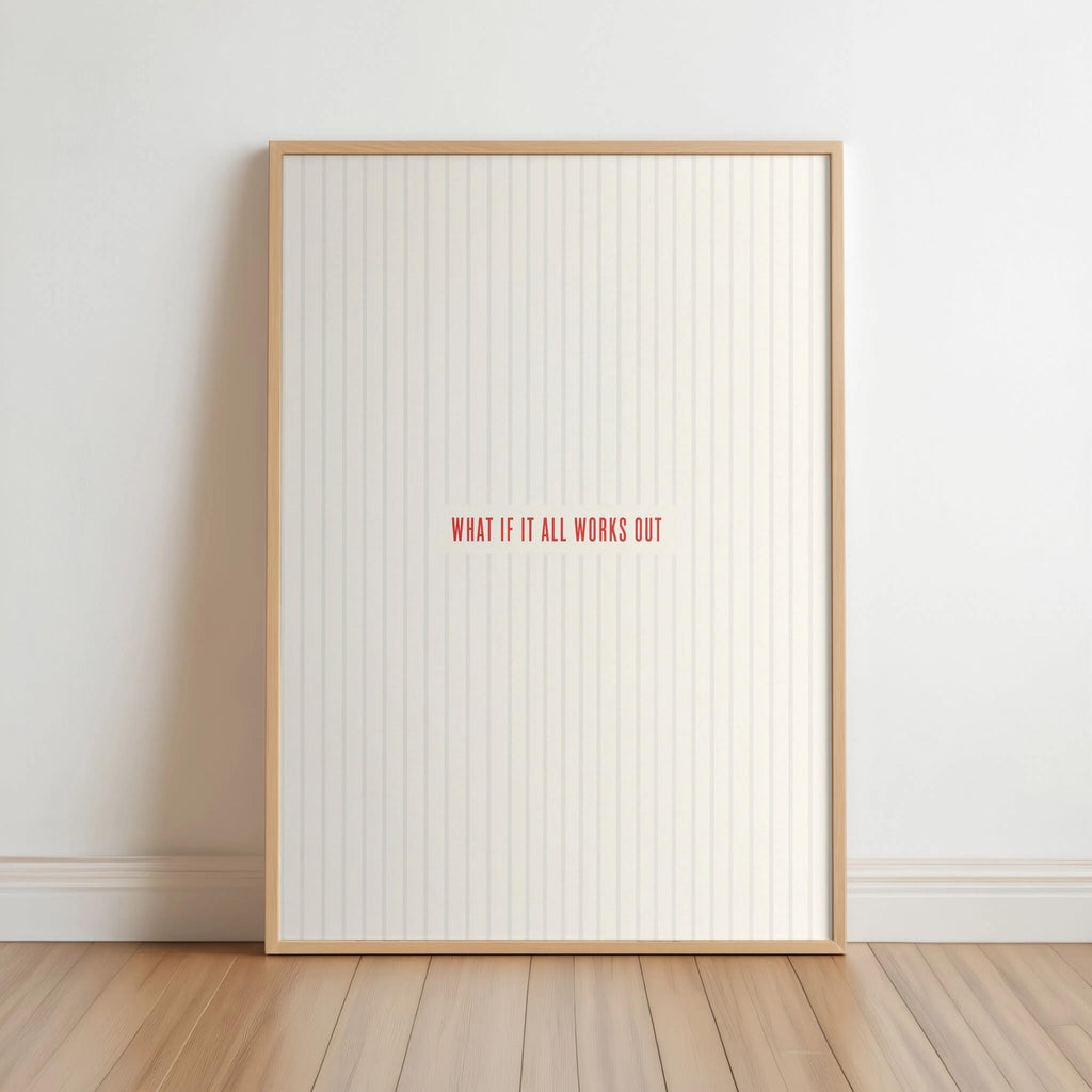 Light wood framed what if it all works out wall art leaning on floor, cream stripes, red type