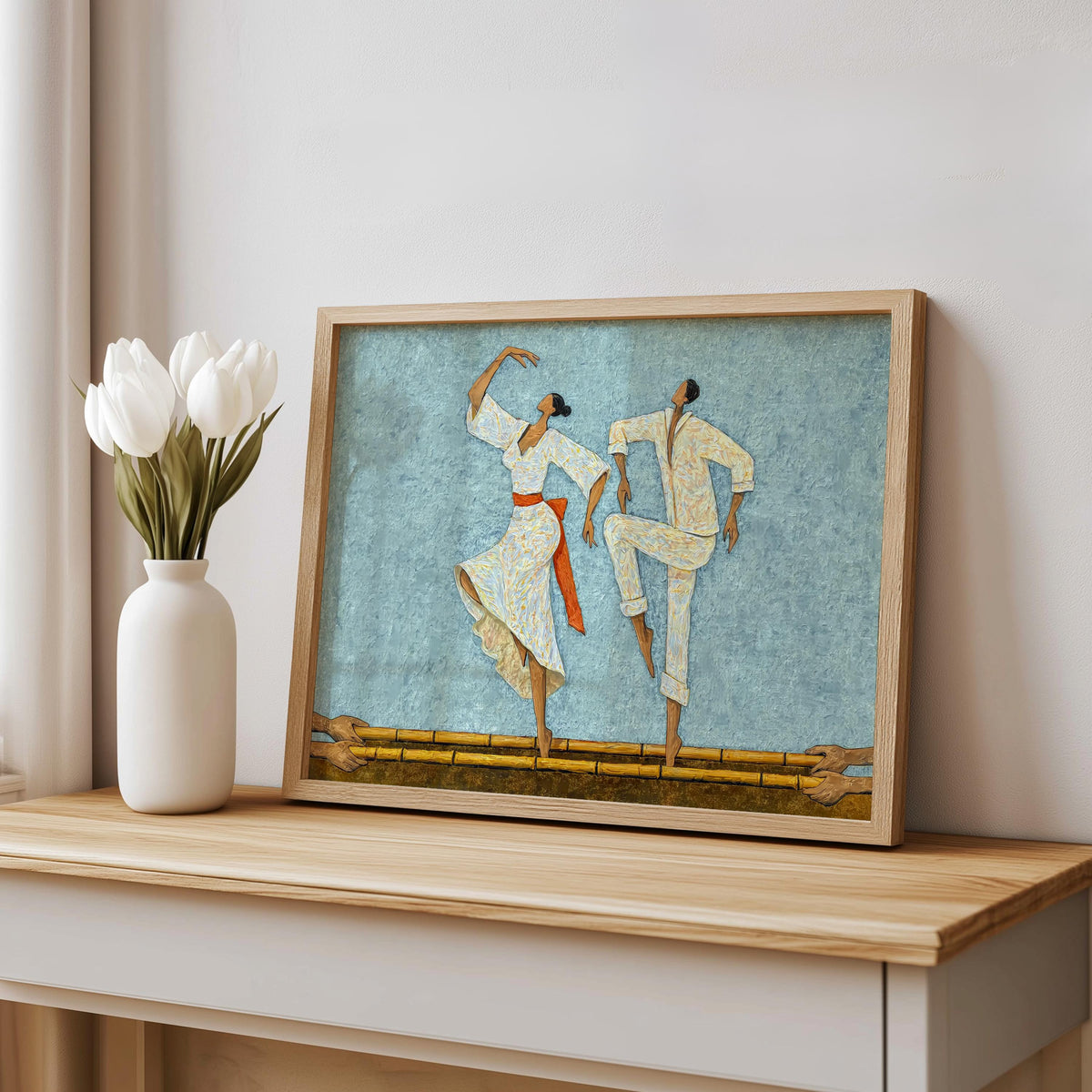 Light blue Filipino Tinikling Art Print styled on shelf, framed leaning against wall beside minimal white vase