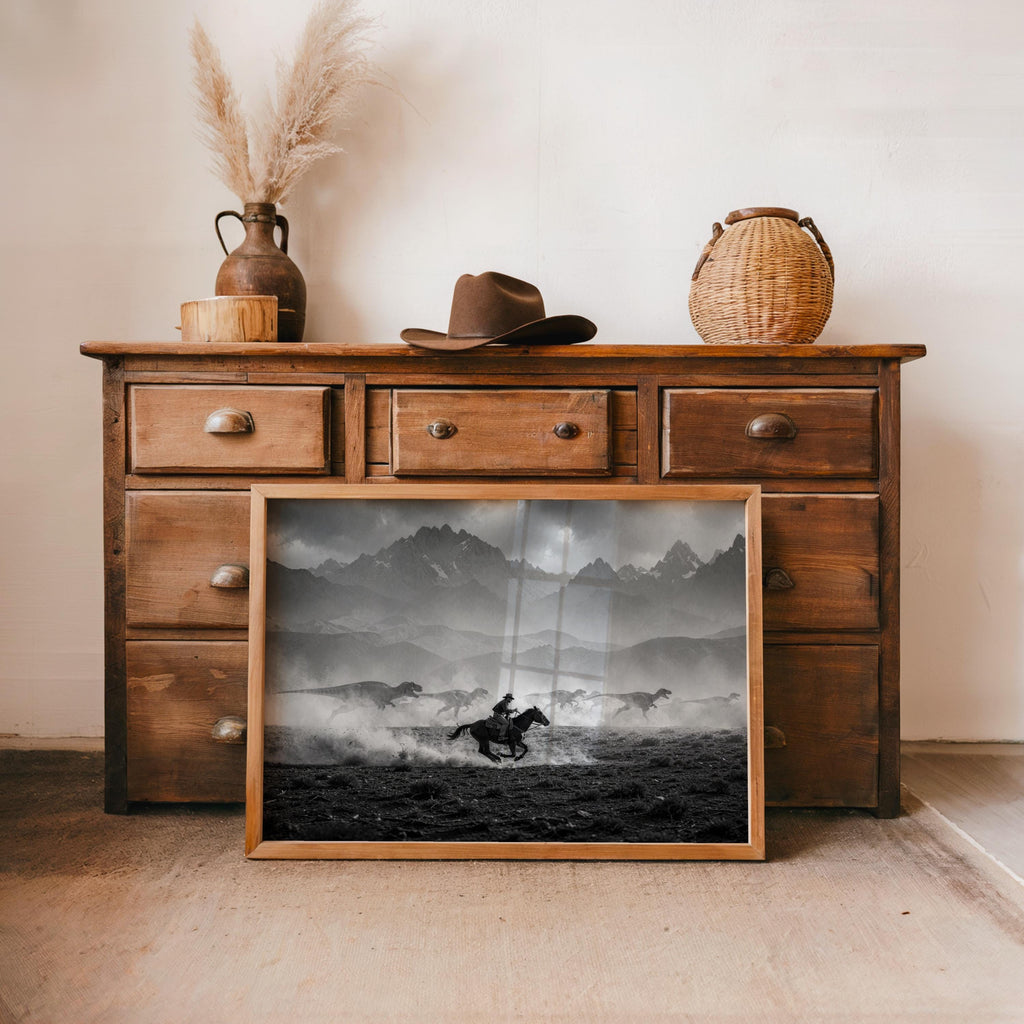 Rustic dresser staging with cowboy dinosaur wall art, moody clouds, archival paper print framed