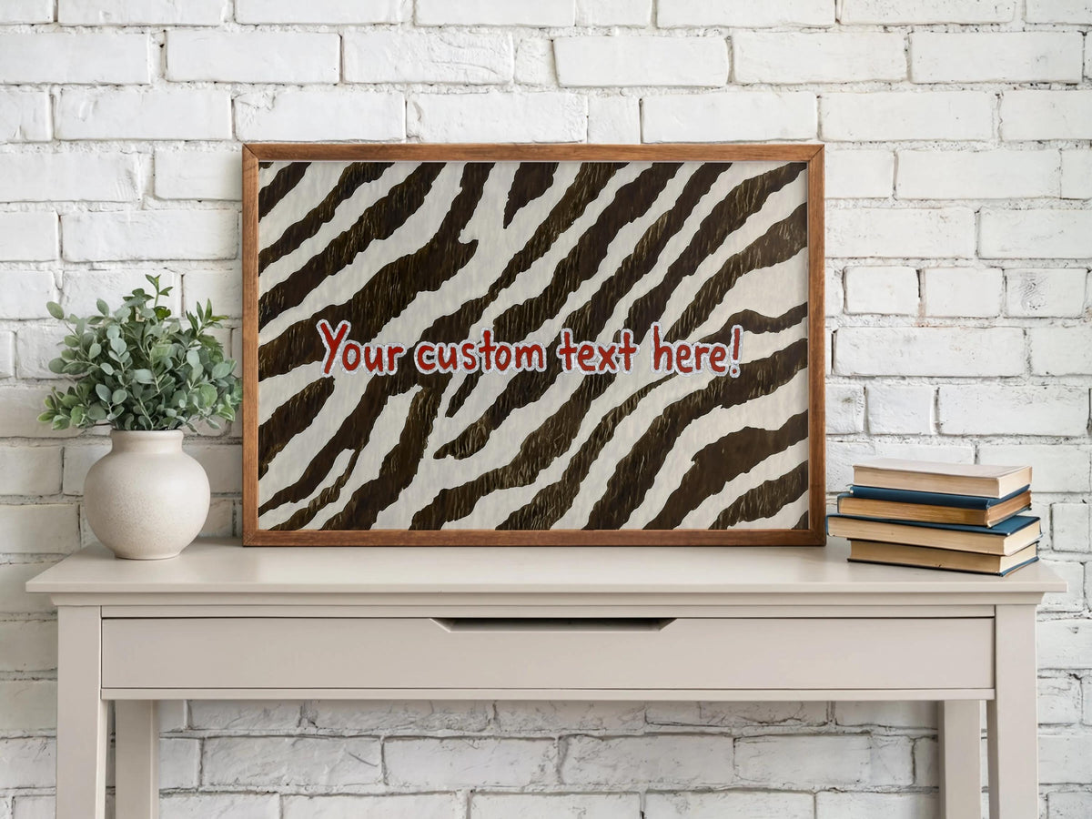 Framed zebra print home decor on a console with potted plant and books, personalized zebra print wall art styled