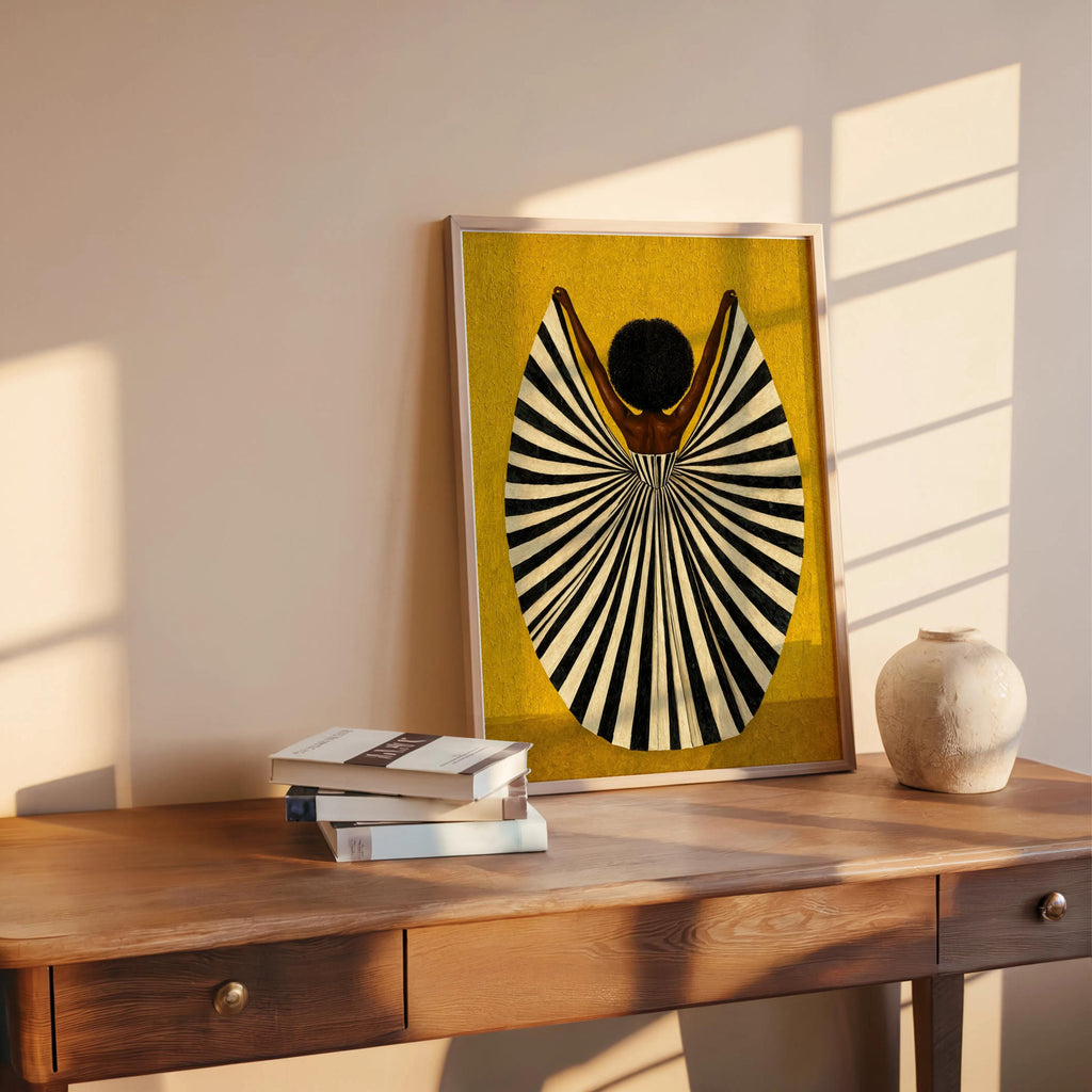 Golden yellow print leaning on shelf beside books, mid century modern wall art vibe, abstract black woman wall art