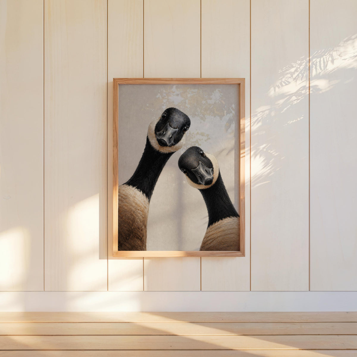 Small framed Canadian geese wall art hung on white paneled wall, playful rustic wildlife decor