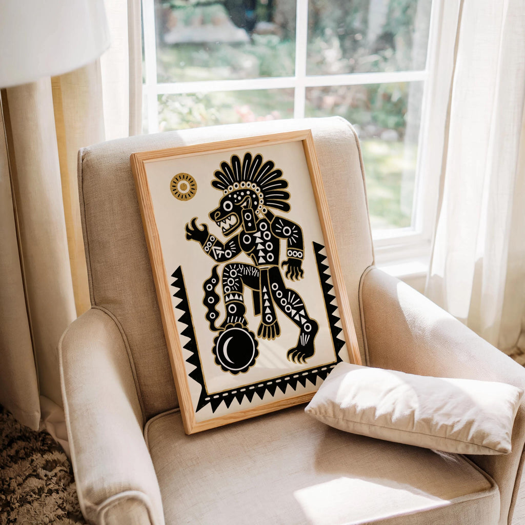 Tezcatlipoca art print resting on a cozy armchair by a window, soft light highlights Aztec mythology print details
