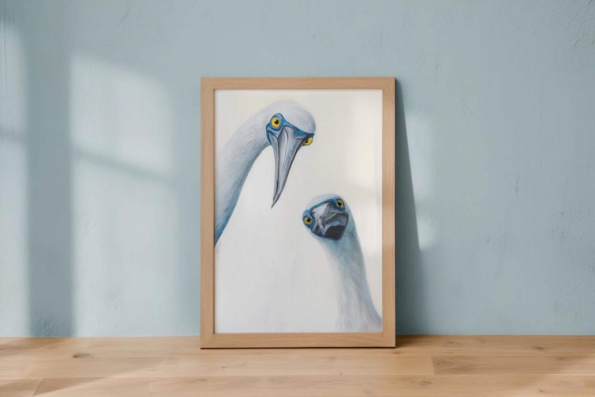 Small frame standing on light wood table with soft shadow, whimsical bird art mockup, blue footed booby wall art print