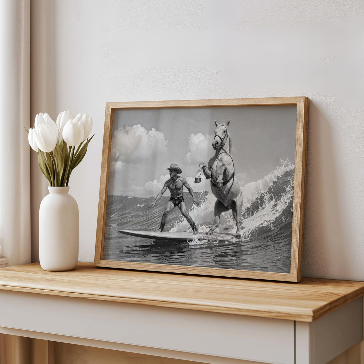 Angled print on bench with white vase, surf cowboy print in rustic wood frame, soft tones