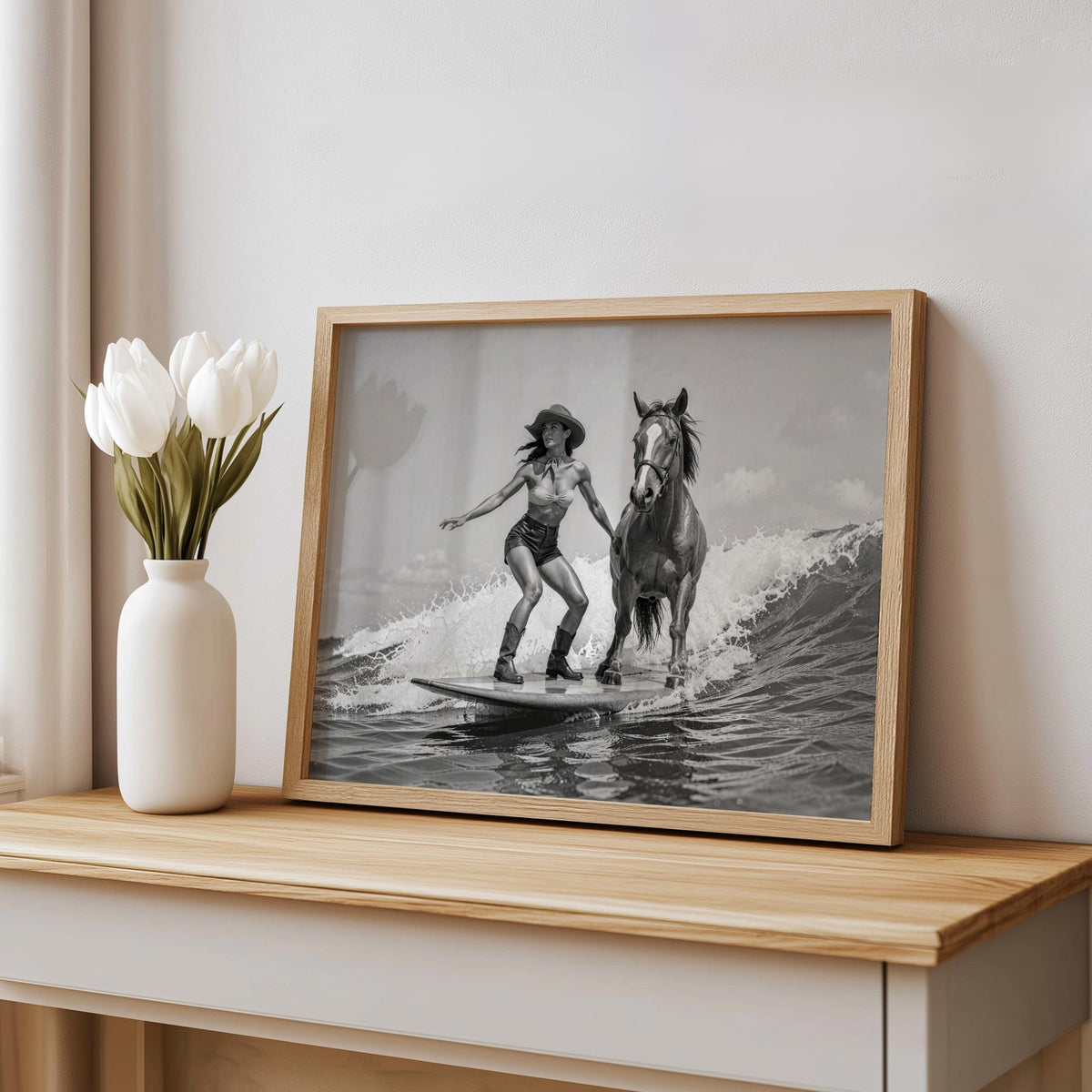 Framed cowgirl horse wall art propped beside a white vase, vintage black-and-white surfing cowgirl print