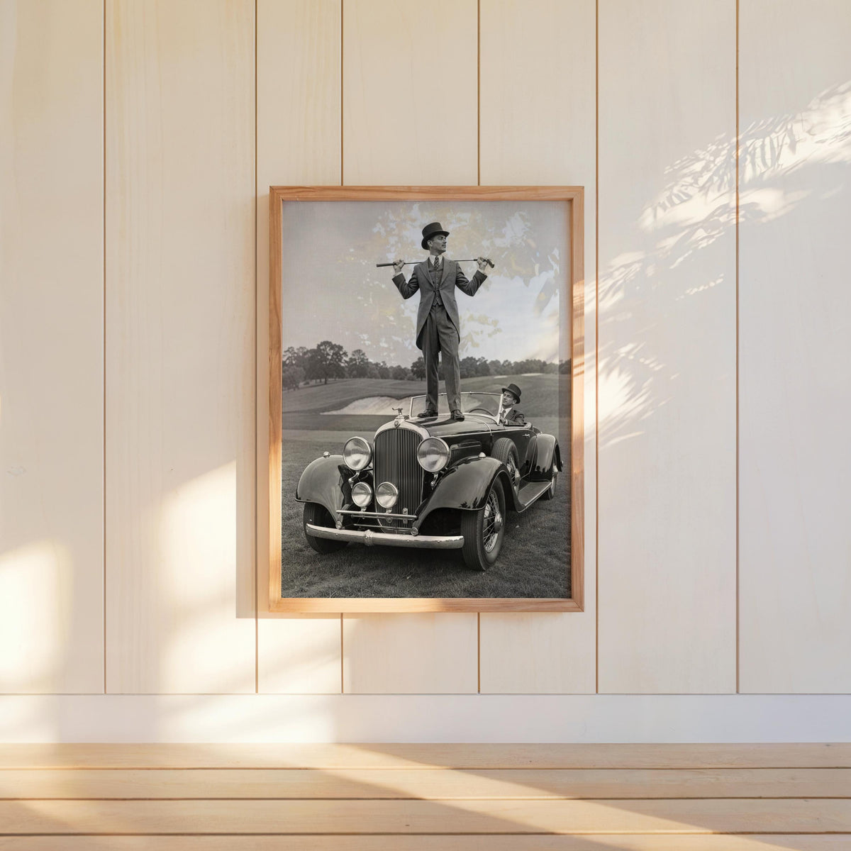 Hanging framed vintage golf wall art on shiplap, monochrome golfer on convertible, masculine office decor