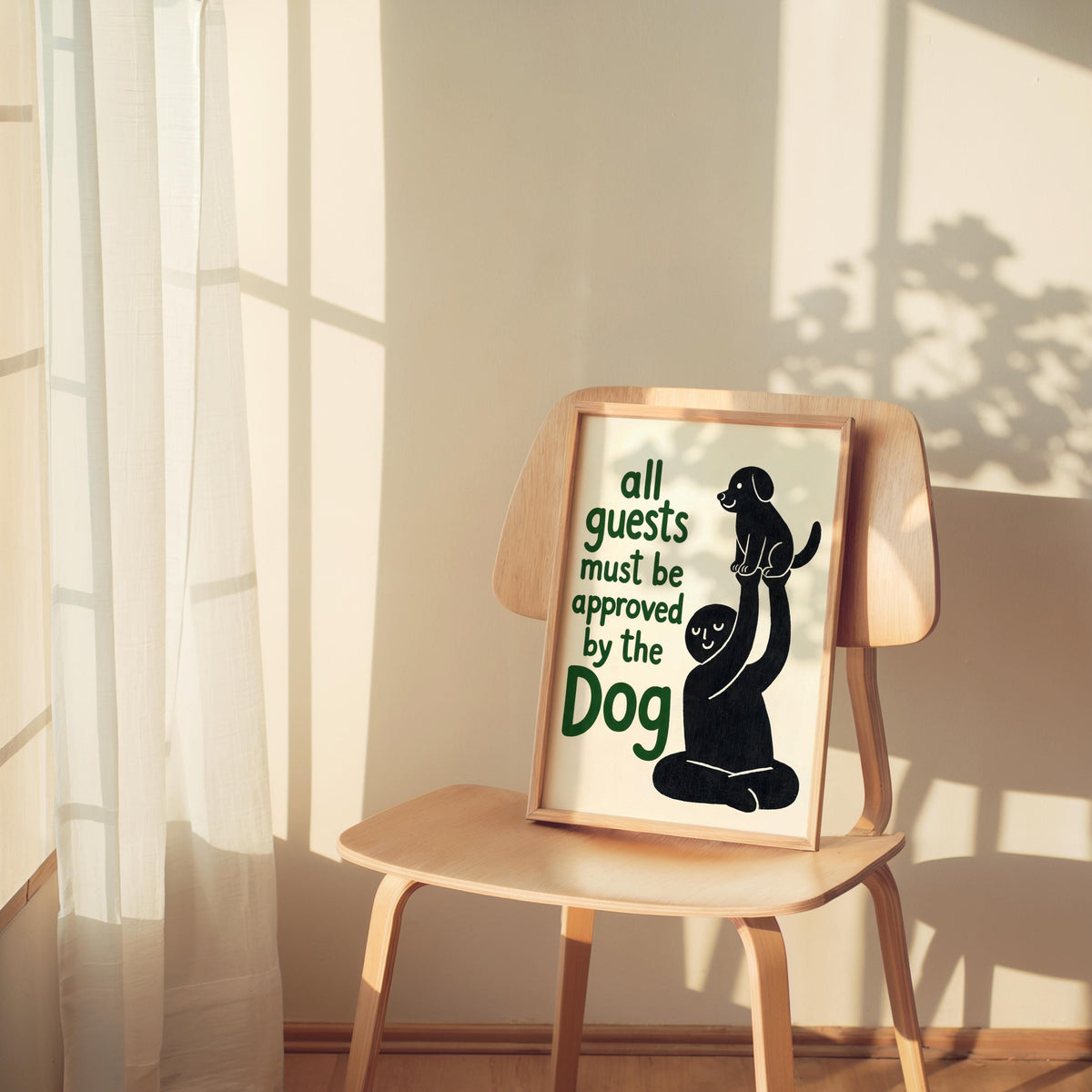 Black dog poster casually placed on a small chair with soft sunbeams, humorous dog print styled as pet lover home decor