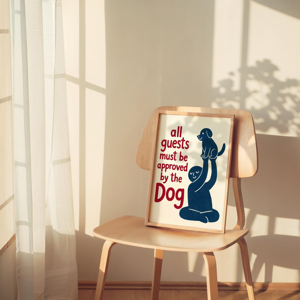 Red-accent dog poster leaning on a chair, strong side light and cozy room styling, funny pet wall art gift idea