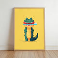 Wood-framed mustard print leaning on floor, cheerful green crocodile holding a toothbrush, kids bathroom wall art