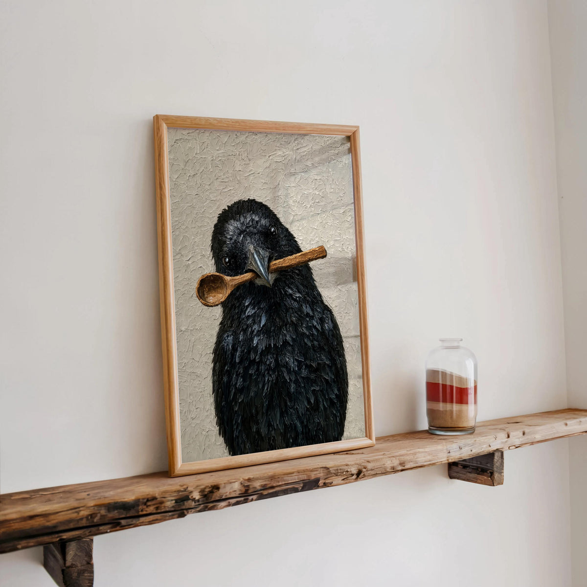 Framed funny crow wall art on a slim shelf against neutral wall, candle accent, whimsical Halloween touch