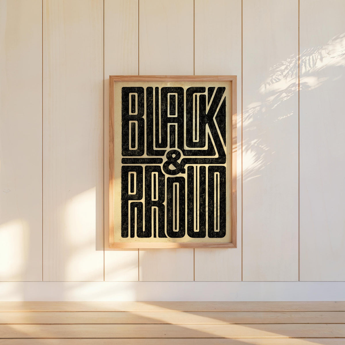 Tall Black and Proud wall art mounted on white shiplap, geometric retro poster aesthetic, vintage gold paper tones