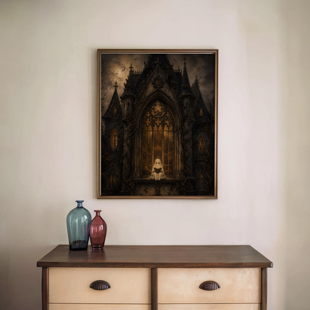Framed gothic haunted house wall art above vintage console table, two decorative vases, witchy home decor accent
