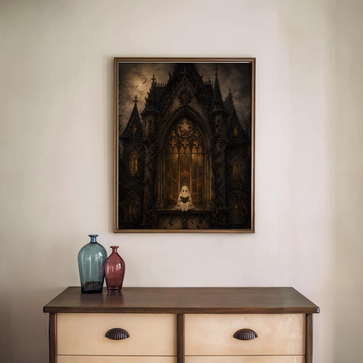 Framed gothic haunted house wall art above vintage console table, two decorative vases, witchy home decor accent