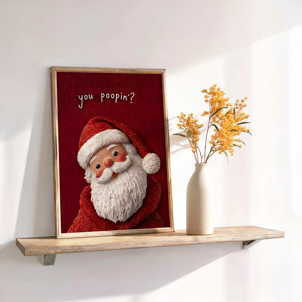 Framed red-background Santa on a shelf with dried florals, cozy nostalgic texture, styled as a holiday restroom poster and funny Christmas bathroom sign.
