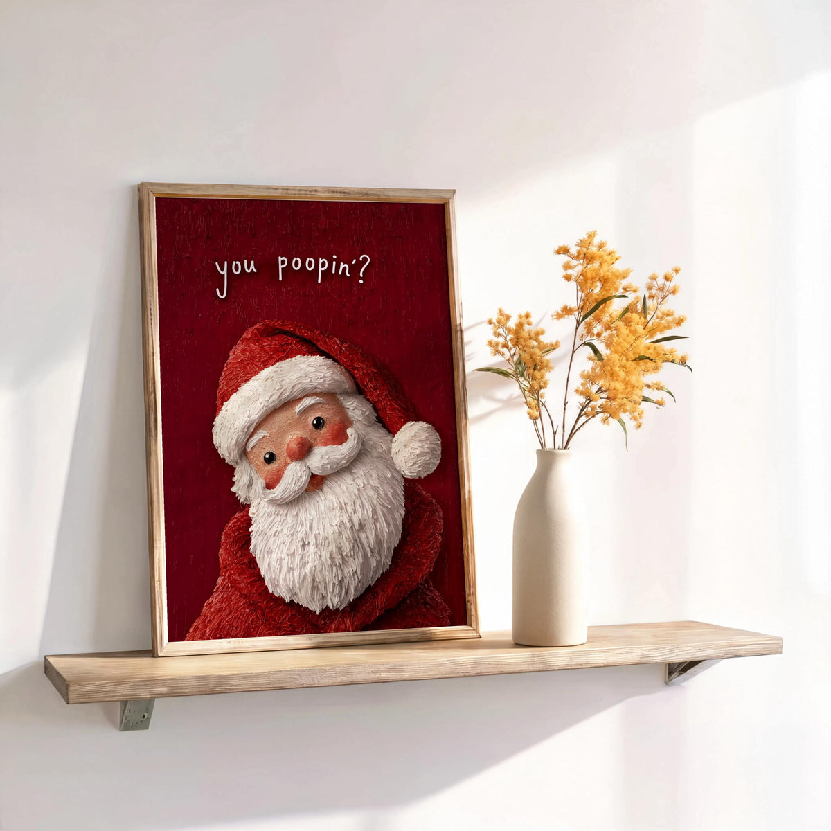 Framed red-background Santa on a shelf with dried florals, cozy nostalgic texture, styled as a holiday restroom poster and funny Christmas bathroom sign.