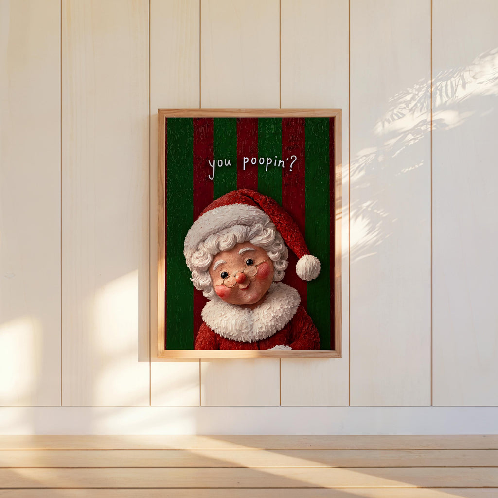 Small framed Mrs Claus print hung on pale paneled wall, green stripes and sunlight, funny Christmas bathroom wall art
