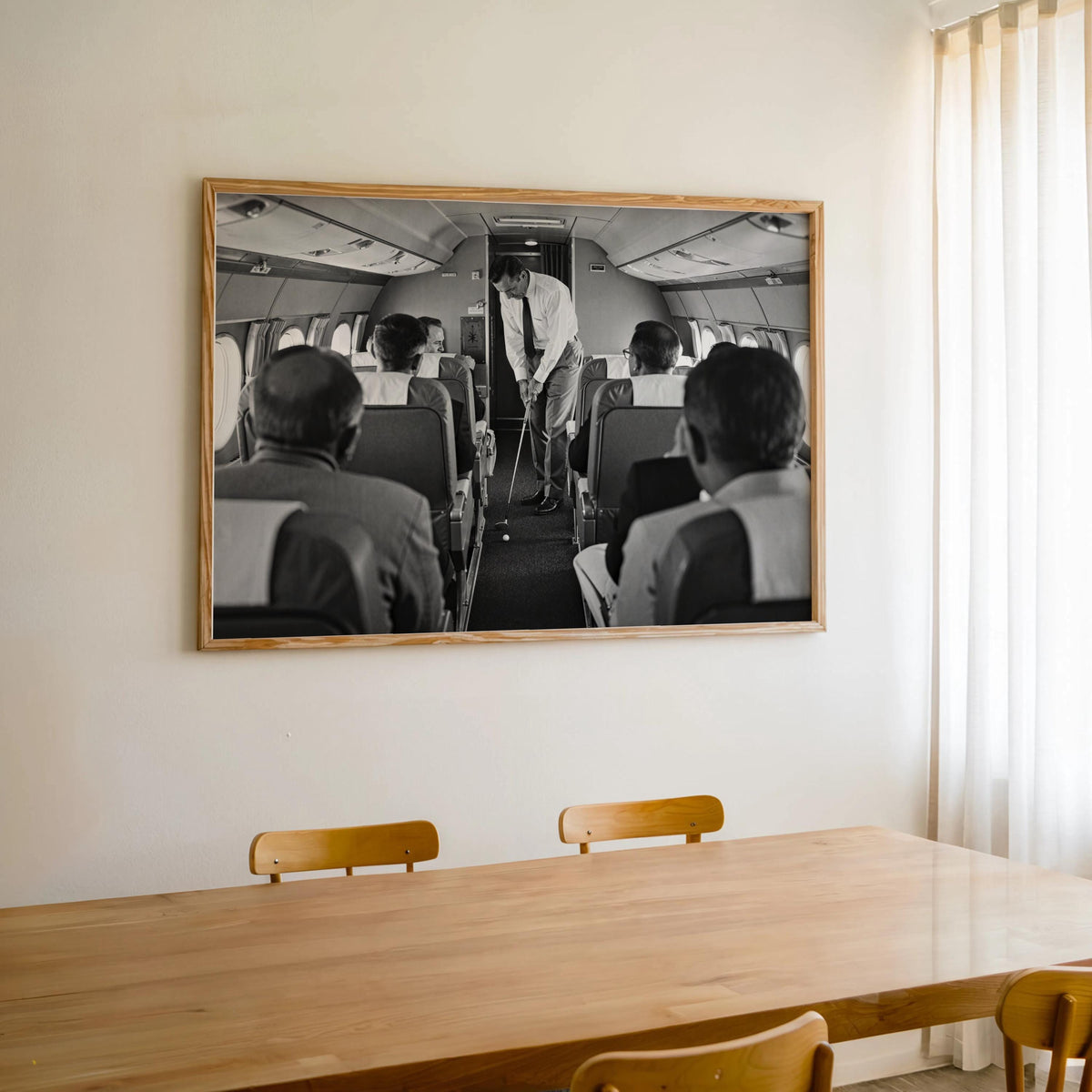 Framed black and white print hanging above dining table, vintage golf print meeting aviation wall art, funny golf wall art