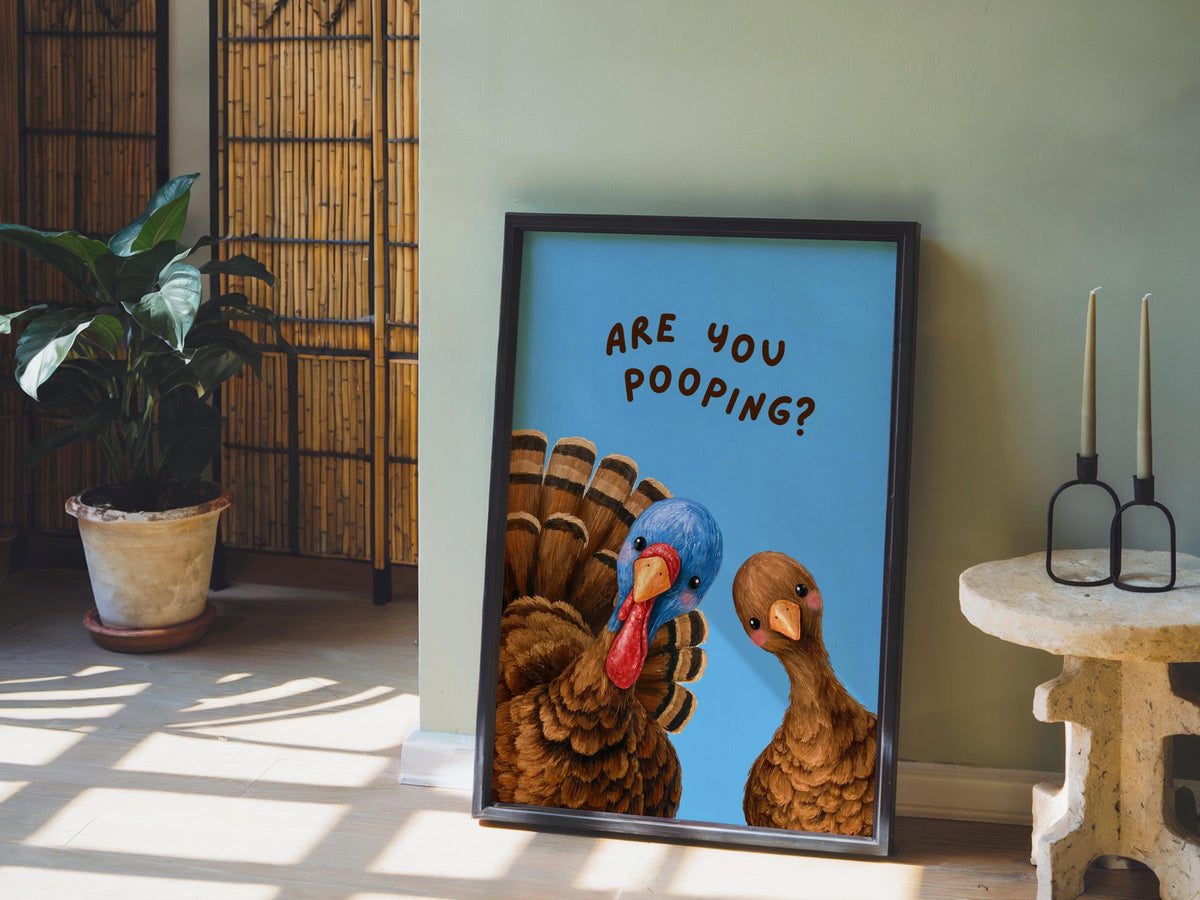 Autumn bathroom decor scene with blue funny turkey bathroom print, potted plant and candles, playful Thanksgiving bathroom decor styling