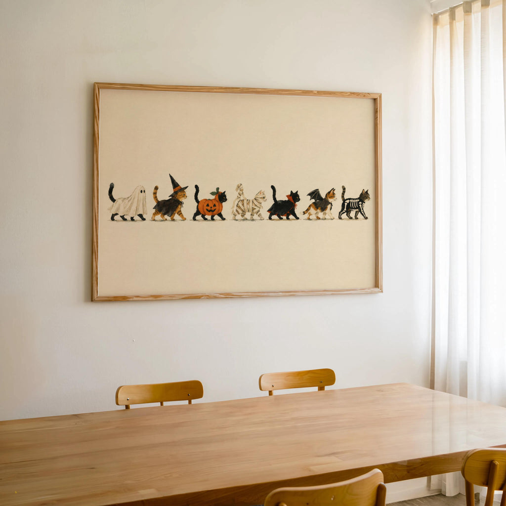 Large framed Halloween cat wall art above dining table, vintage Halloween wall decor vibe.