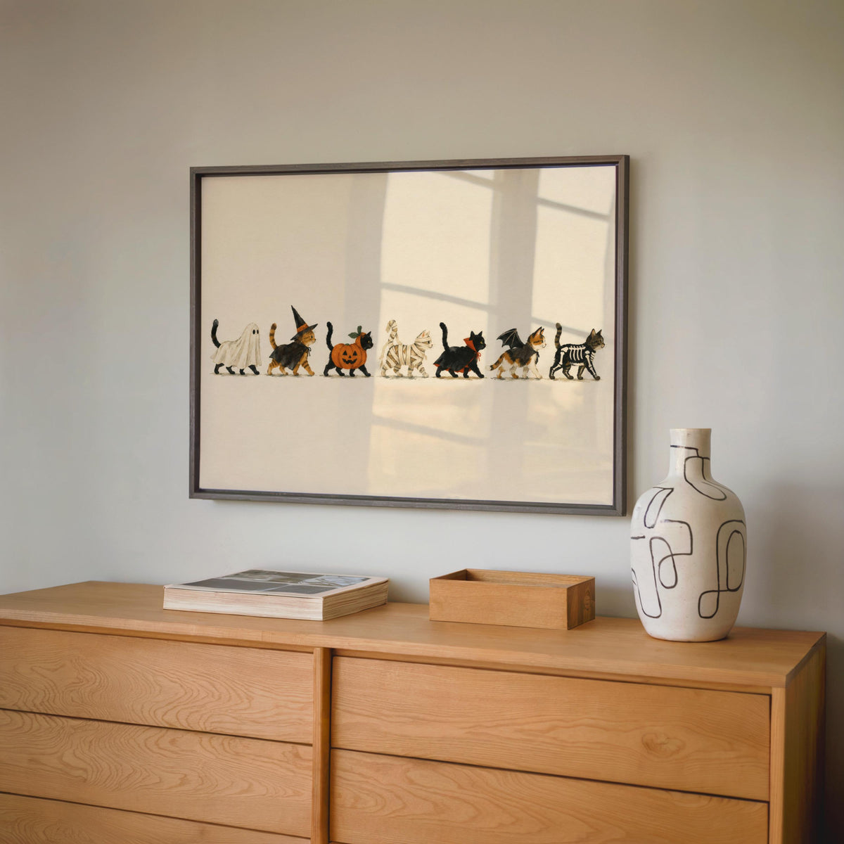 Framed Halloween cat wall art with soft reflections, spooky cat art print, understated storybook aesthetic.