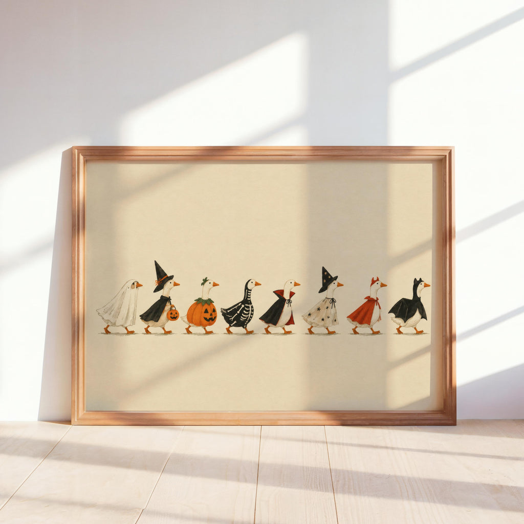 Sunlit wood-framed Halloween duck print leaning against wall, cream background, ducks in costumes