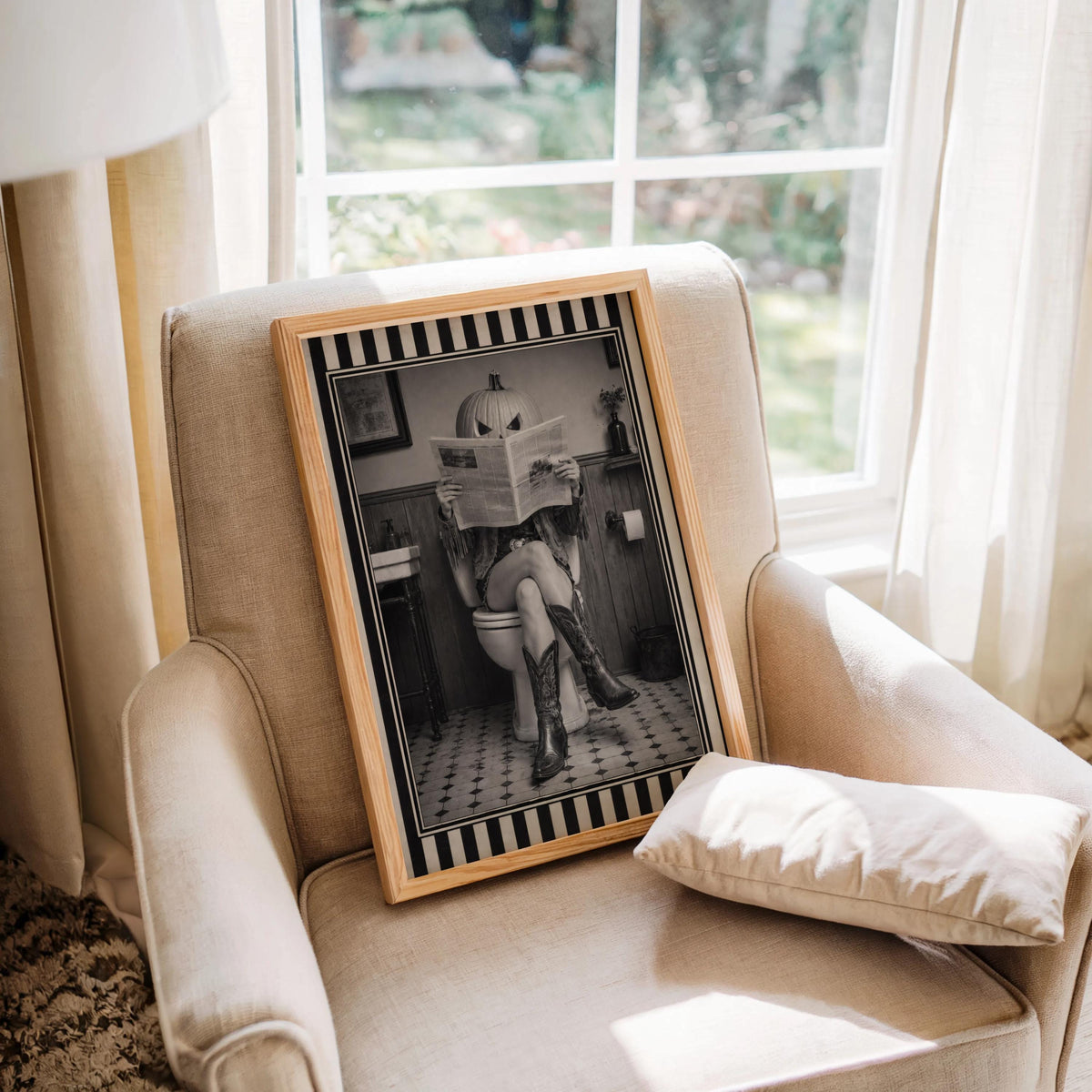 Black and white pumpkin head cowgirl art print propped on an armchair, jack o lantern cowgirl for Halloween