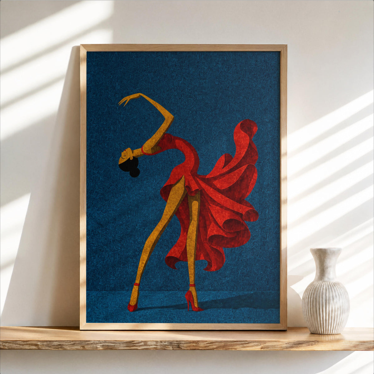 Framed salsa dancer wall art on deep blue background, flowing red dress, small vase on shelf
