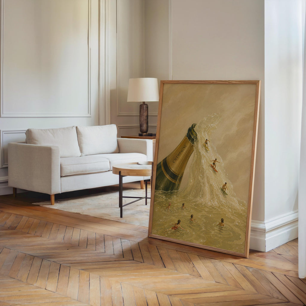 Large champagne bottle wall art leaning against living room molding, oak floors, vintage bar poster feel