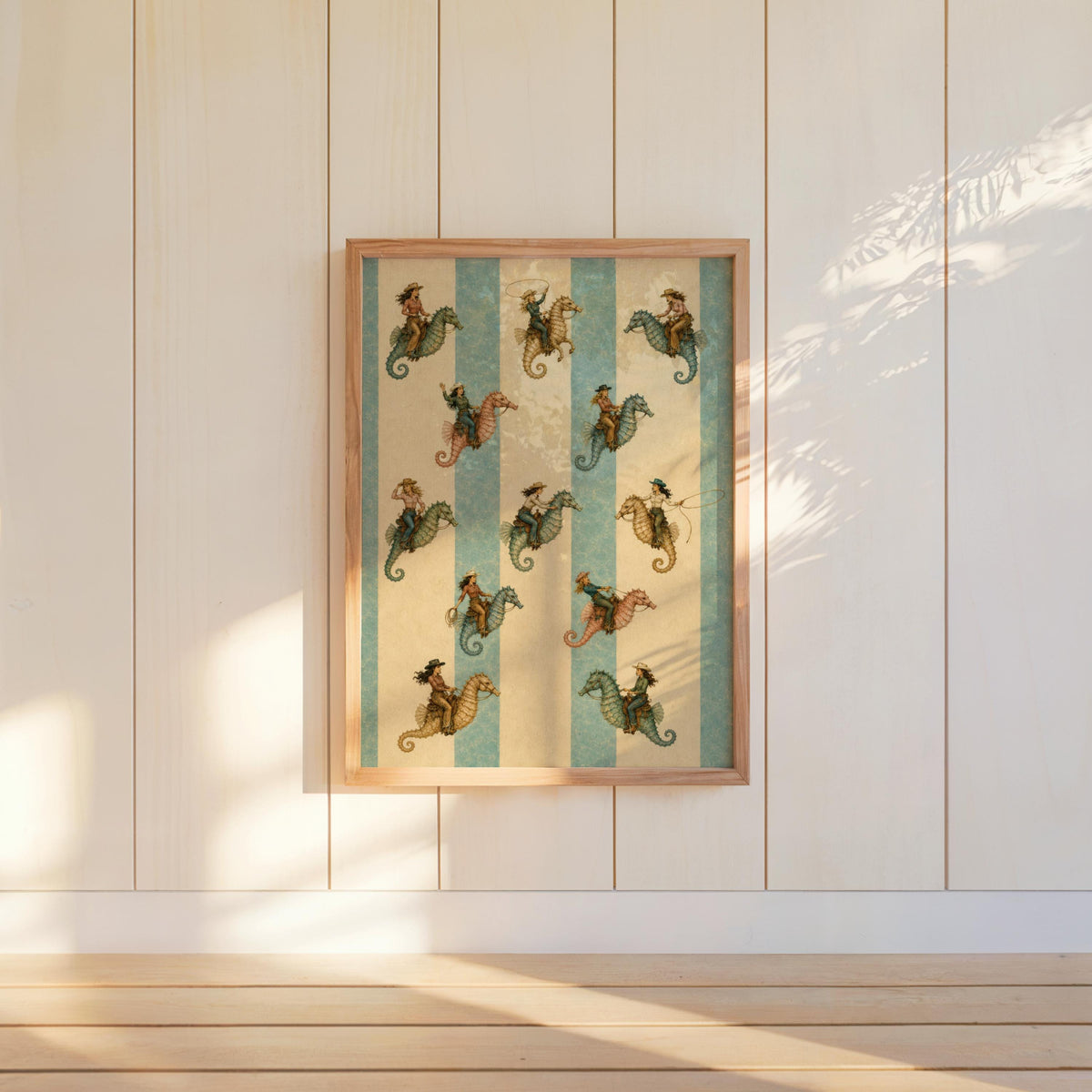 Framed coastal cowgirl wall art centered on white shiplap, vintage nautical cowgirl art with warm sunlight