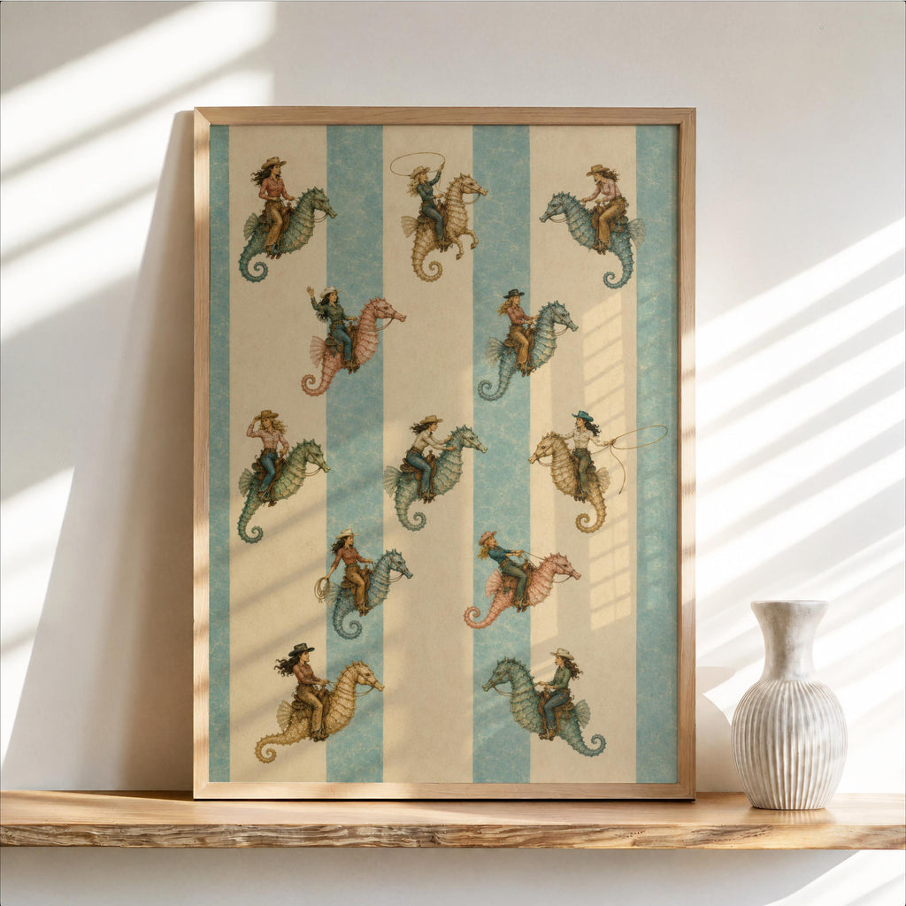Framed coastal cowgirl wall art leaning on a wood shelf, repeating cowgirl-on-seahorse aqua stripes