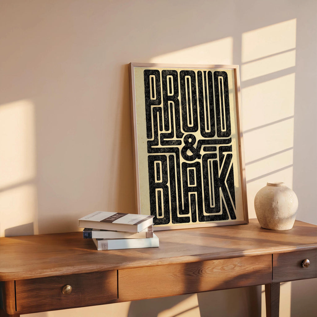 Sunlit console table with distressed black pride poster, small pottery accent, retro typography poster styling