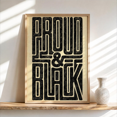 Framed black pride poster leaning on a wood shelf, distressed cream background, vase and soft shadows