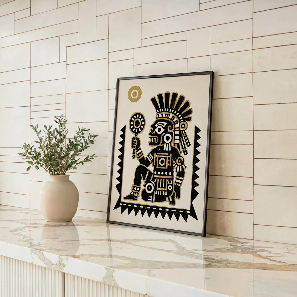 Framed Tezcatlipoca art print on a marble counter next to a plant, Aztec religion art in a modern kitchen setting