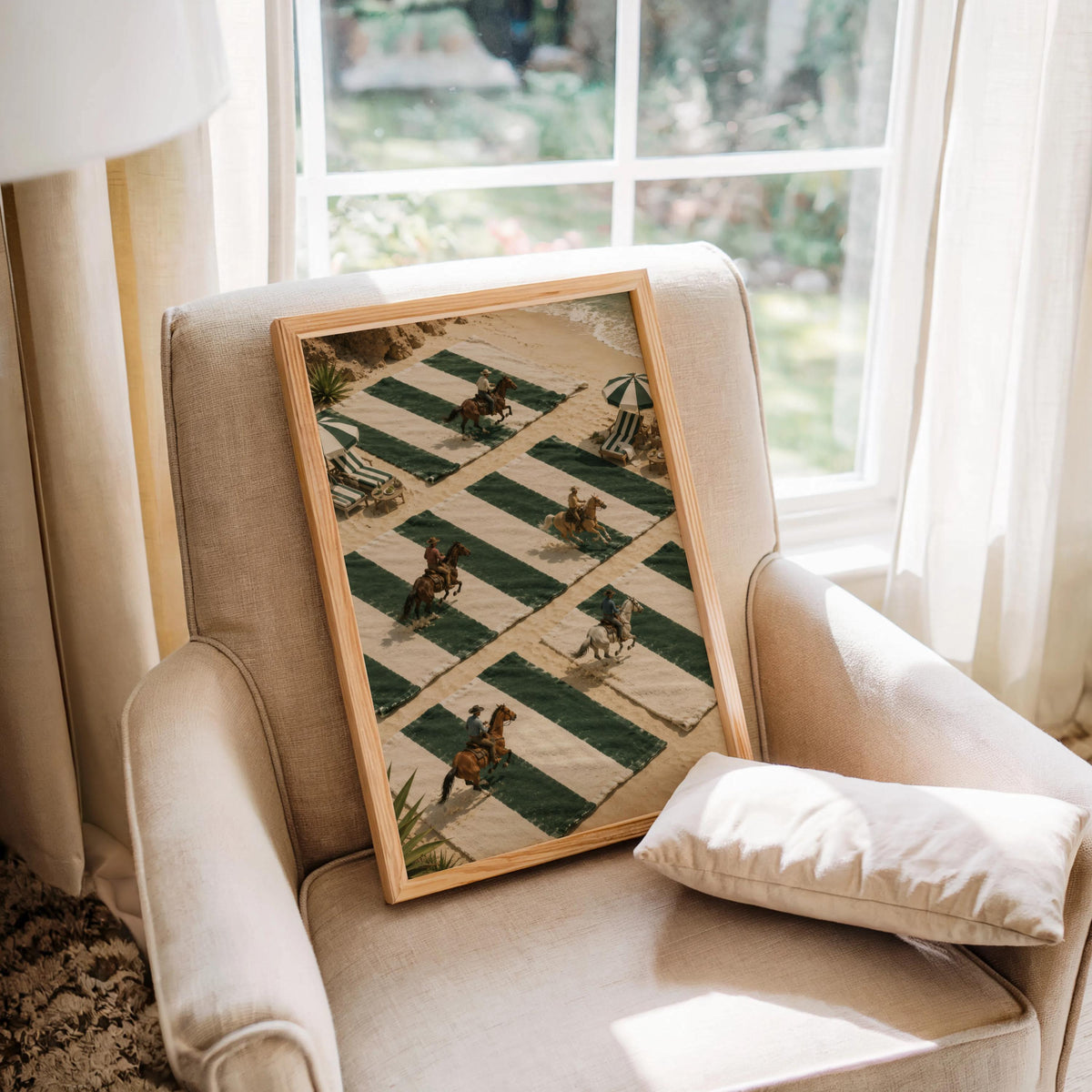 Equine wall art propped on armchair by window, playful tiny cowboy art print on green striped beach towels, sunlit frame