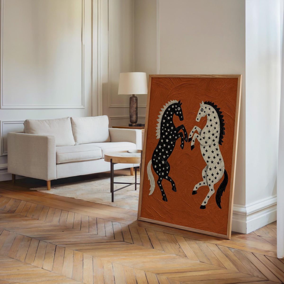 Leaned western horse wall art in a bright living room, hardwood floor and sofa, folk art horse print with bold black and white contrast