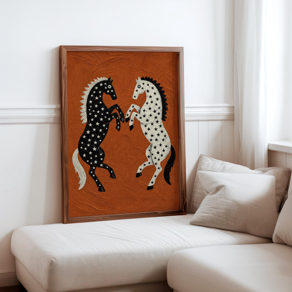 Leaning black and white horse print on a neutral sofa with pillows, cozy living room display, equestrian wall art with rust orange textured field