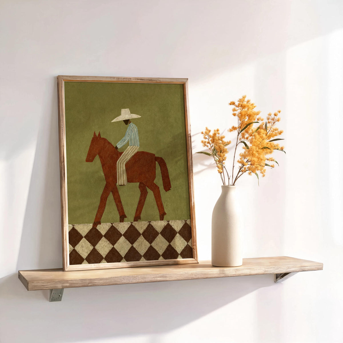 Framed abstract western wall art on shelf with vase of dried flowers, warm light, folk art cowboy print vibe
