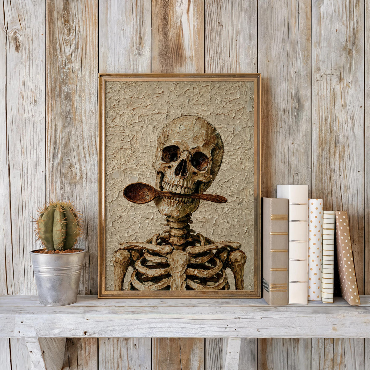 Vintage skeleton chef wall art framed against weathered wood, small cactus and stacked books, macabre kitchen decor vibe.