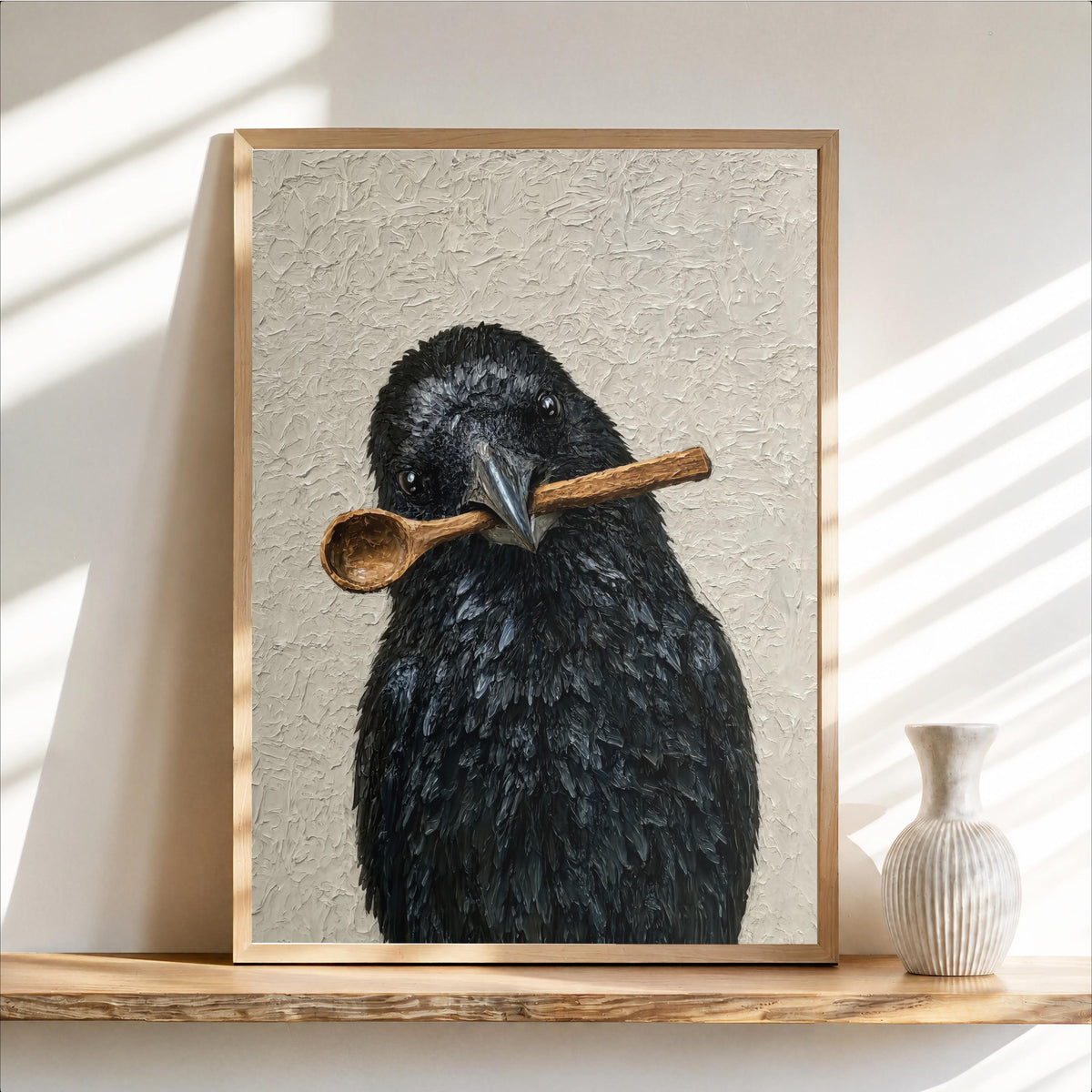 Framed funny crow wall art leaning on a rustic shelf, textured beige background, wooden spoon across beak