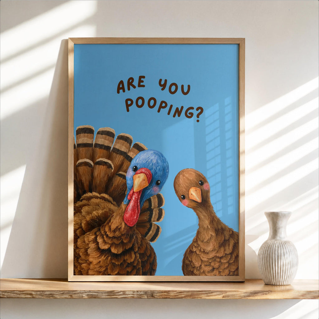 Framed funny turkey bathroom print with bright blue background, oversized feathers and playful, humorous restroom print text