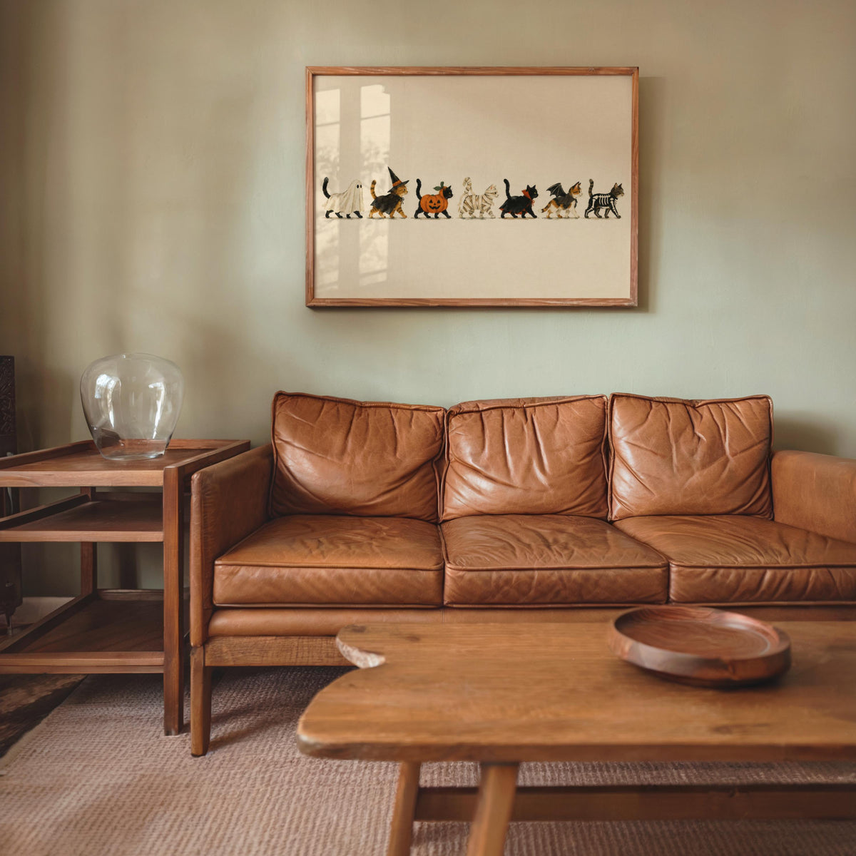 Horizontal Halloween cat wall art above leather sofa, Halloween gallery wall art, subdued vintage colors.