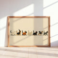 Framed horizontal Halloween cat wall art leaning on sunlit floor, cream background, playful parade.