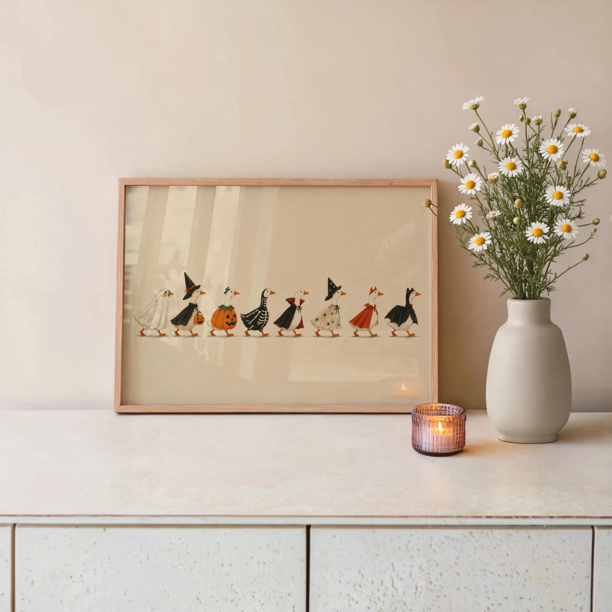 Unframed Halloween duck print leaning on console with wildflowers and candle, folk art Halloween decor