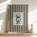 Framed vintage Halloween print on a floating shelf, striped cream and olive background, ghost on toilet, funny bathroom wall art