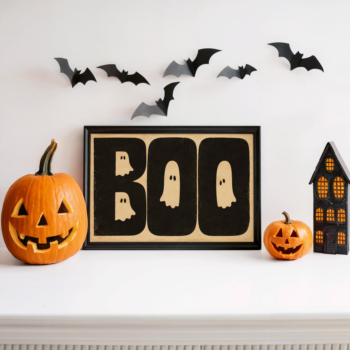 BOO print displayed with carved pumpkin and bat decals, playful spooky season decor, ghost Halloween wall art in wood frame