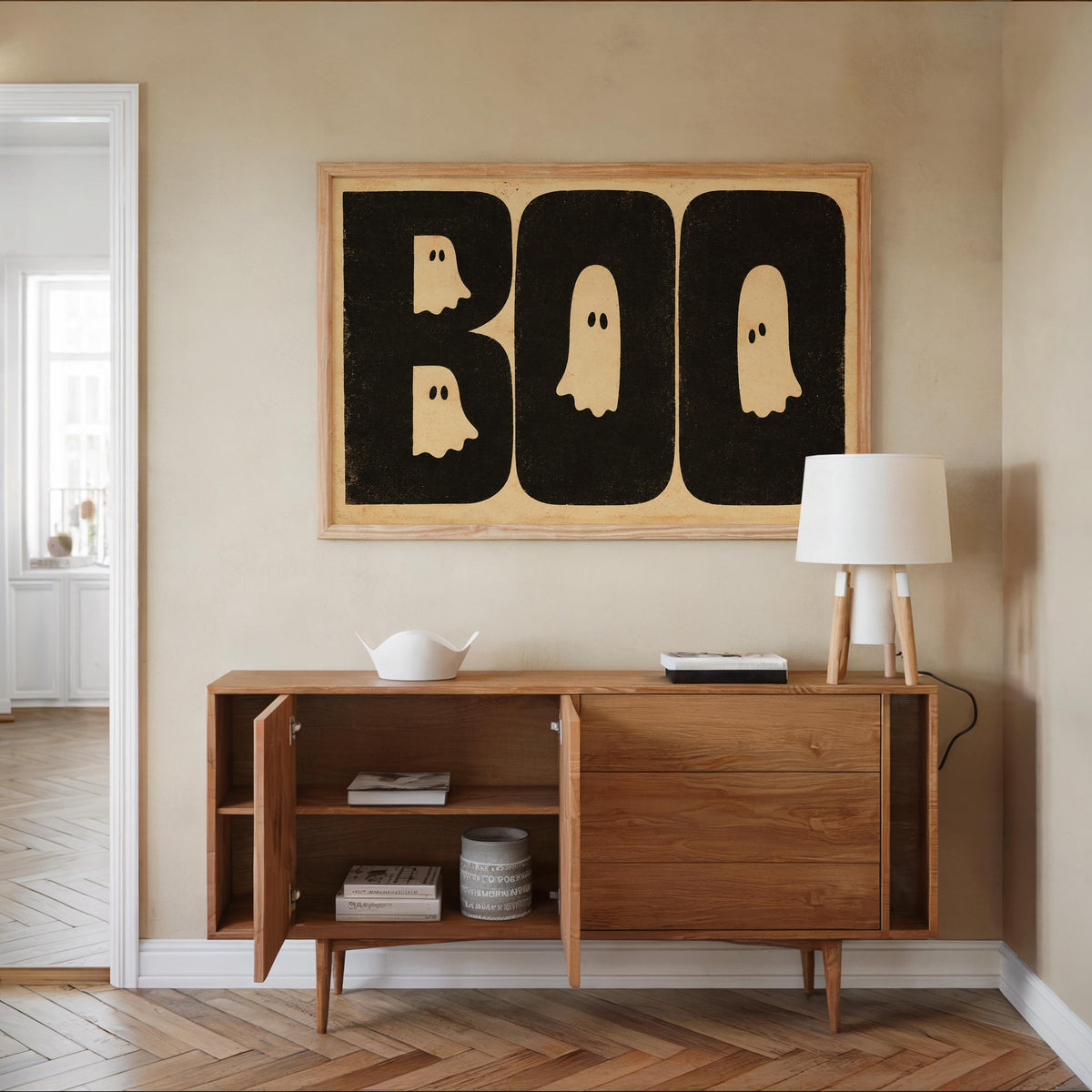 Entry console styled with Halloween BOO wall art above, vintage Halloween wall decor in cream and black, warm wood tones