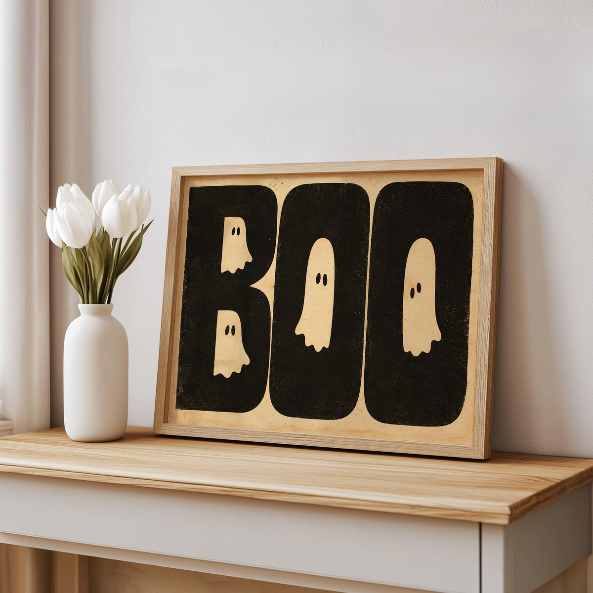 BOO ghost print leaning on a bench beside a white vase, distressed paper texture, playful retro Halloween poster styling